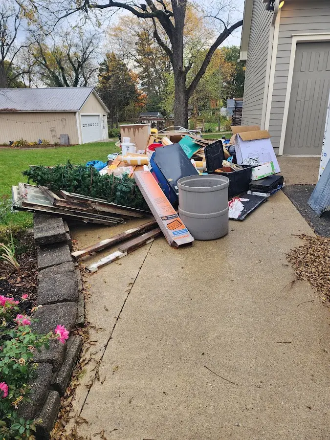 Dumpster being loaded with debris for Residential Dumpster Rental in St. Cloud